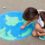 the-child-girl-draws-a-globe-with-a-map-of-the-wor-CEHAD8R - 01